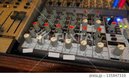 Close Up of Audio Mixer Knobs with Red and Blue Indicators 135847310
