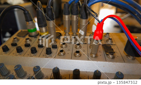 Close Up of Audio Cables and Connectors Plugged into Mixer Close Up of Audio Cables and Connectors Plugged into Mixer 135847312