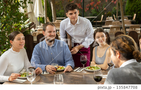 Waiter takes order from group of friends 135847708