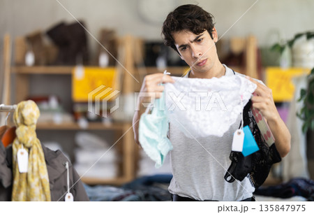 In chain shop, man choose ladys lingerie panties In chain shop, man choose ladys lingerie panties 135847975