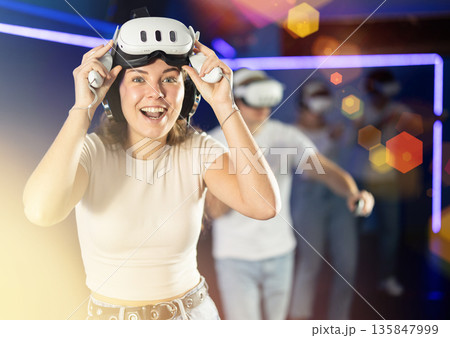 Stunned by exciting game, girl lowered helmet and took break from game. 135847999
