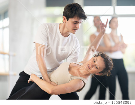 Young guy and adult woman rehearsing pair ballet Young guy and adult woman rehearsing pair ballet 135848095
