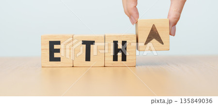 Hand change Wooden block with ETH or Ethereum text to UP and Down arrow symbol. cryptocurrency, blockchain, price, down and up, decrease and increase, cut loss, trade and financial concepts 135849036