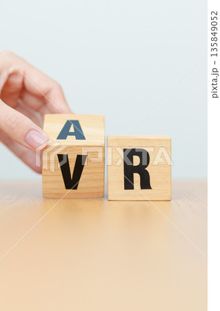 hand change wooden block from VR to AR, VIRTUAL and AUGMENTED REALITY, MR, Mixed Reality, XR, Extended, Metaverse and Immersive Technology concept hand change wooden block from VR to AR, VIRTUAL and AUGMENTED REALITY, MR, Mixed Reality, XR, Extended, Metaverse and Immersive Technology concept 135849052