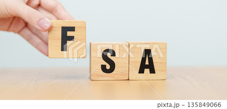 hand change wooden block of FSA. HSA, Flexible Spending Account and Health Savings Account, Medical Expenses, Tax Benefits and healthcare concepts hand change wooden block of FSA. HSA, Flexible Spending Account and Health Savings Account, Medical Expenses, Tax Benefits and healthcare concepts 135849066