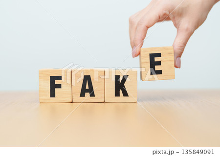 wooden block FAKE . rumor News, false, myth, evidence and disinformation concepts 135849091