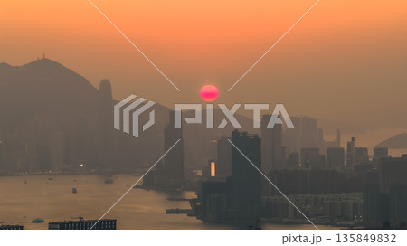 Jan 18 2026 Hong Kong island sunset over Kowloon harbour. 135849832