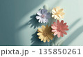 Colorful paper flowers casting shadows on pastel background create serene and artistic composition. delicate petals and soft hues evoke sense of tranquility and creativity 135850261