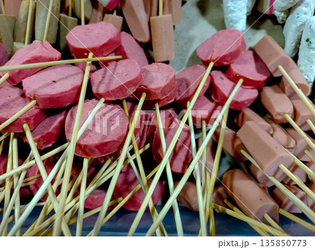 Sliced Red Sausages and Hot Dogs on Bamboo Skewers for Grilling Sliced Red Sausages and Hot Dogs on Bamboo Skewers for Grilling 135850773