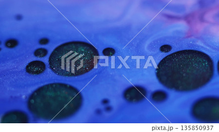 Flowing droplets. Shiny fluid. Defocused blue purple color round paint oil chemical enamel water floating on abstract wet background. Flowing droplets. Shiny fluid. Defocused blue purple color round paint oil chemical enamel water floating on abstract wet background. 135850937