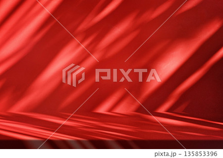 Stucco Table with Red Background with Leaf Shadows 135853396