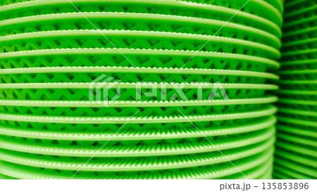 Stack of Green Plastic Drainage Trays or Floor Mats with Grid Texture Stack of Green Plastic Drainage Trays or Floor Mats with Grid Texture 135853896