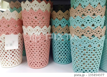 Pastel Colored Decorative Plastic Lace Baskets Stacked on Shel 135854377