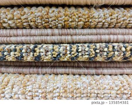 Stack of Various Textured Carpet Samples in Earth Tones 135854381