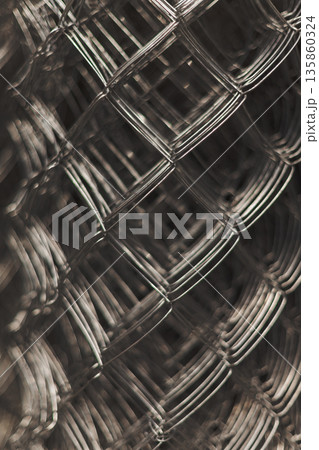 Abstract Close-Up Of Interwoven Metal Wire Mesh, Highlighting Industrial Texture 135860324