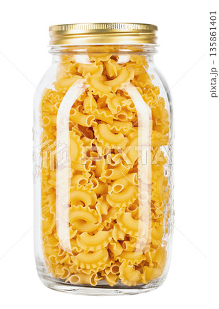 Dried macaroni cockerel scallops. Pasta in a glass jar isolated on a white background. 135861401