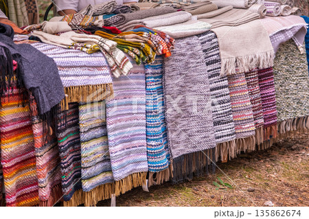 Traditional colorful woven rugs at outdoor market Traditional colorful woven rugs at outdoor market 135862674