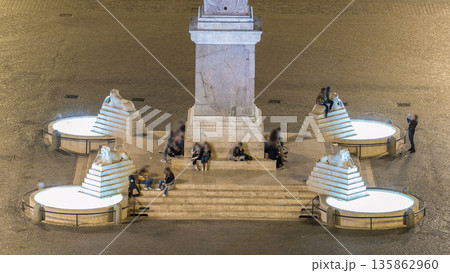 people are gathering under the central column on piazza del popolo during night timelapse 135862960