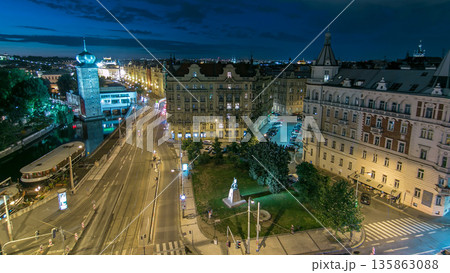 Sitkovska water-tower night timelapse and traffic on road in old city center of Prague. 135863088