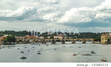 View of the city Prague in Czech Republic with colorful paddle boats timelapse on the Vltava river on a beautiful day View of the city Prague in Czech Republic with colorful paddle boats timelapse on the Vltava river on a beautiful day 135863113