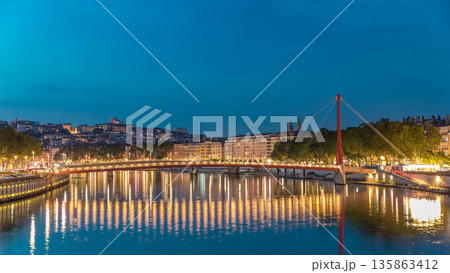 Hyperlapse of the Passerelle du Palais du Justice bridge over the Saone River in Lyon, transition from day to night timelapse. 135863412