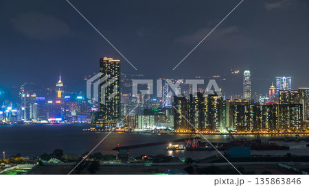 Top view of Hong Kong at night, aerial view from Kowloon bay downtown timelapse Top view of Hong Kong at night, aerial view from Kowloon bay downtown timelapse 135863846