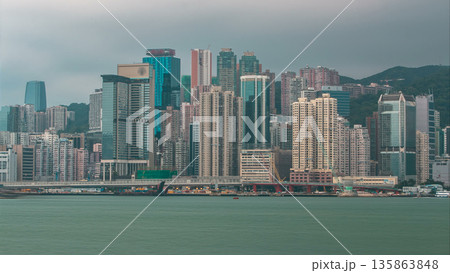 Hong Kong skyline in the morning over Victoria Harbour timelapse. 135863848