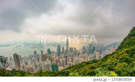 The famous view of Hong Kong from Victoria Peak timelapse. Sunrise with colorful clouds over Kowloon Bay. 135863859