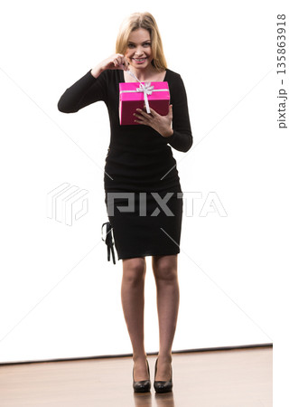 Girl opening pink gift box Girl opening pink gift box 135863918