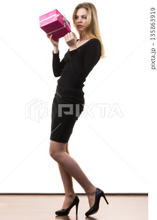 Girl opening pink gift box Girl opening pink gift box 135863919