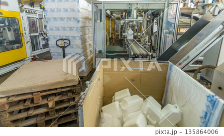 A factory for plastic canister production timelapse hyperlapse. The conveyor in the factory. 135864006