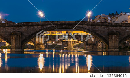 Ponte Alla Carraia and Santa Trinita Holy Trinity Bridge day to night timelapse over River Arno in Florence 135864013