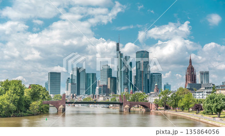 Hyperlapse of Frankfurt's skyscrapers skyline with the bell tower overlooking Alte Brucke. Frankfurt, Germany Hyperlapse of Frankfurt's skyscrapers skyline with the bell tower overlooking Alte Brucke. Frankfurt, Germany 135864056