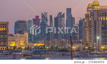 View from Katara Beach day to night timelapse in Doha, Qatar, towards the West Bay and city center View from Katara Beach day to night timelapse in Doha, Qatar, towards the West Bay and city center 135864059