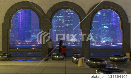 View at the heart of finance world of Doha night timelapse thought the three arches 135864105