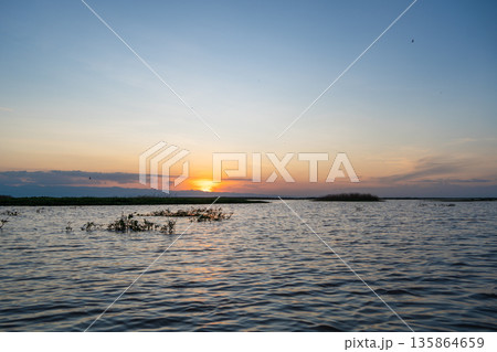 Sunset over Lake Tempe in Sulawesi, Indonesia's peaceful waters Sunset over Lake Tempe in Sulawesi, Indonesia's peaceful waters 135864659