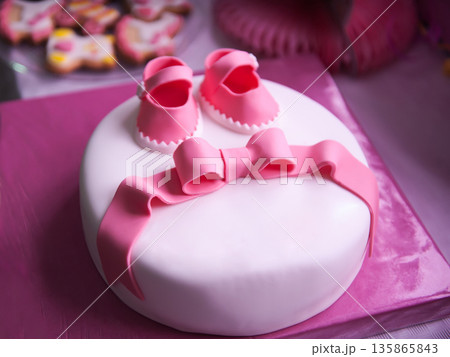 Beautiful children's pink cake for a newborn girl Beautiful children's pink cake for a newborn girl 135865843