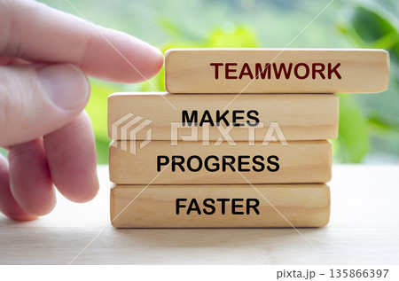 Teamwork motivation concept shown through wooden blocks emphasizing efficiency cooperation and faster organizational progress. 135866397