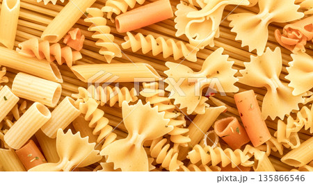 Assorted dry pasta shapes background for concept of italian food, cooking, or ingredients 135866546
