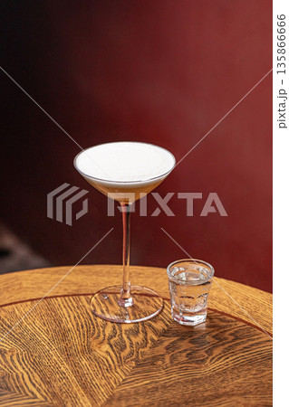 Sour style cocktail with foam and side shot Sour style cocktail with foam and side shot 135866666