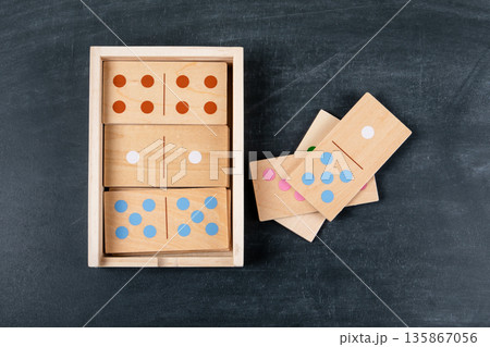 Wooden Domino Game Set In Open Storage Box On Dark Background Wooden Domino Game Set In Open Storage Box On Dark Background 135867056