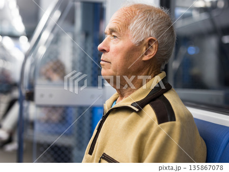 Portrait of elderly european man 75 years old sitting in underground carriage 135867078