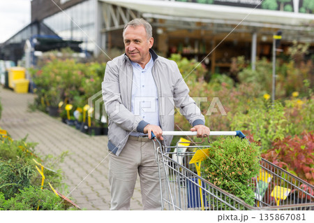 Caucasian man choosing sprouts in garden center Caucasian man choosing sprouts in garden center 135867081