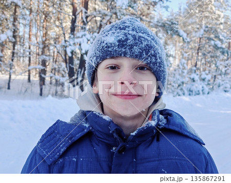 Christmas, New Year, winter holidays concept. Cute teenage boy in snow park. portrait of a happy teenage boy in winter. Christmas, New Year, winter holidays concept. Cute teenage boy in snow park. portrait of a happy teenage boy in winter. 135867291