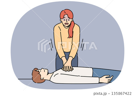 Woman nervous, giving heart massage to man who has fainted, pressing on chest muscles 135867422