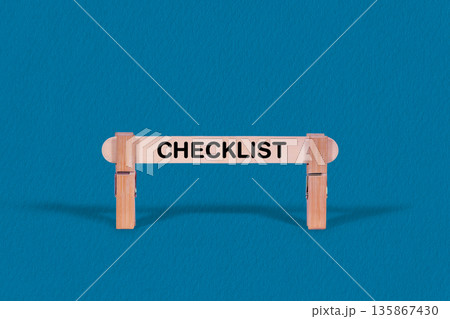 Checklist symbol. Single Wooden stick confined by  Clothespins, Cool Blue Background. Business and Checklist concept with copy space 135867430
