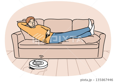 Robot vacuum cleaner is controlled using remote control, cleaning room with guy lying on sofa Robot vacuum cleaner is controlled using remote control, cleaning room with guy lying on sofa 135867446