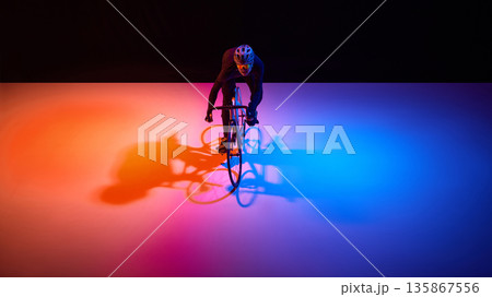 Professional cyclist maintaining focus during high intensity training ride. Professional cyclist maintaining focus during high intensity training ride. 135867556
