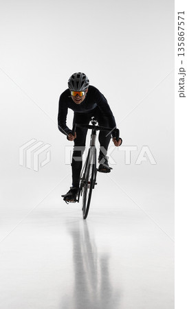 Front view of cyclist riding road bicycle isolated on white background. 135867571