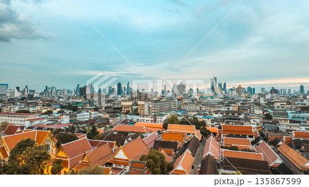 Panorama of Bangkok skyline from Wat Saket temple rooftop, Cityscape view with Thai temple roofs and urban horizon Panorama of Bangkok skyline from Wat Saket temple rooftop, Cityscape view with Thai temple roofs and urban horizon 135867599